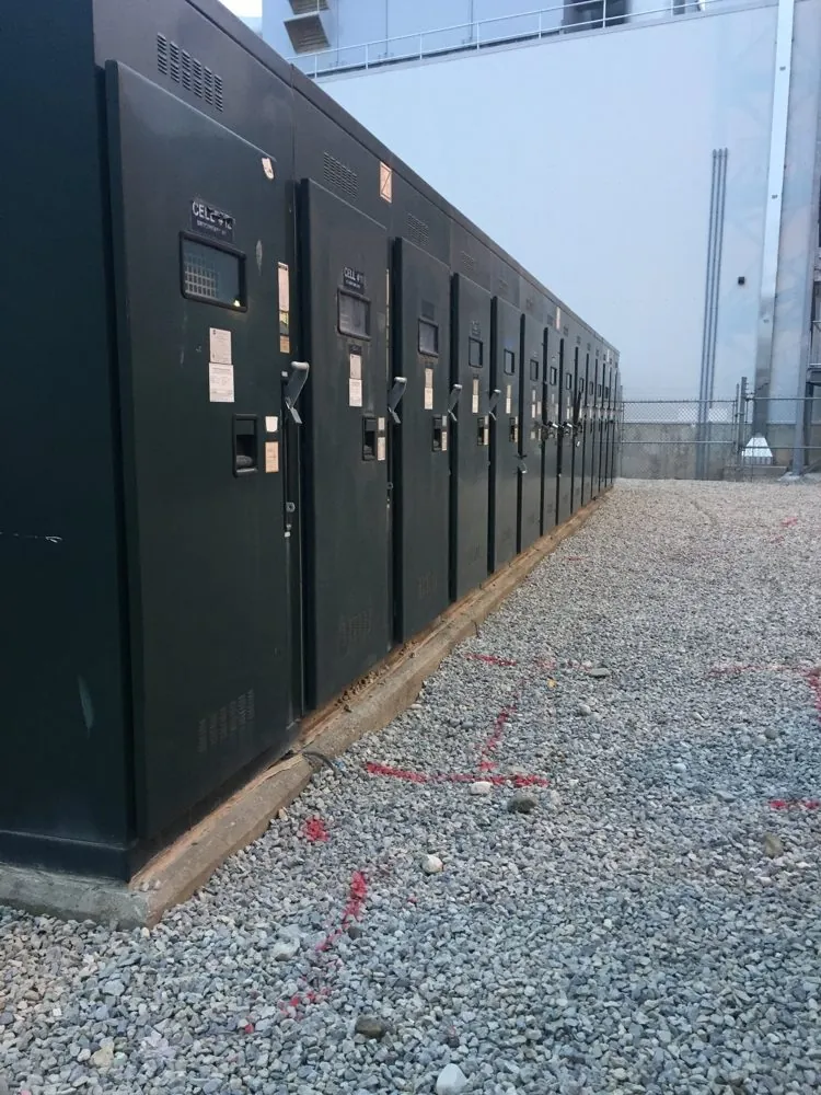 Row of medium voltage switchgear cabinets at an outdoor substation